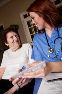 Nurse helping a woman with her medication