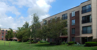 Laurel Place & Buckingham Mansion, an apartment housing option, surrounded by grass and trees
