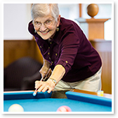 Woman playing pool in a retirement community
