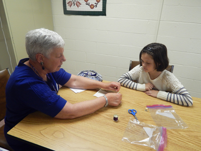 Resident helping a young girl