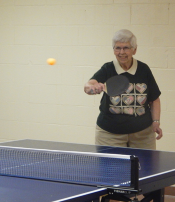 Resident LaVerne Longenecker participates in table tennis during the Senior Games