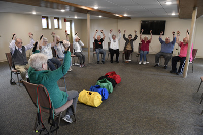 A group of seniors exercising together in a retirement community