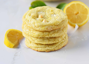 Four lemon white chocolate chip cookies stacked on top of each other 