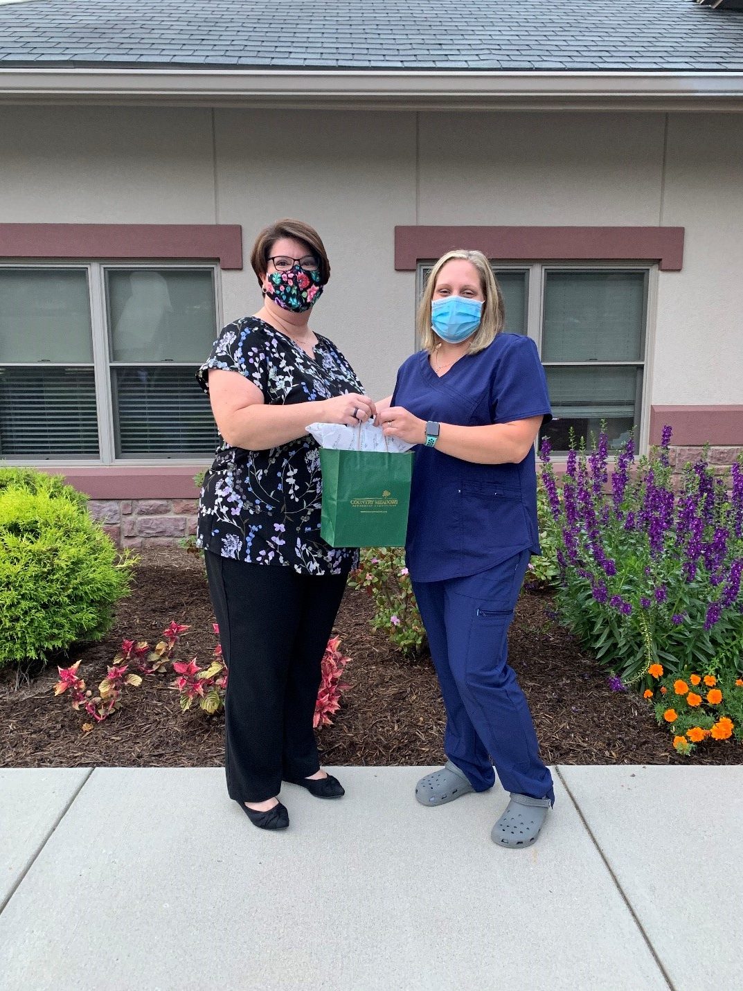 Ashley Belleman and standing next to her nursing instructor