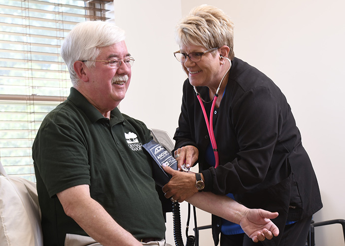 Linda Field, LPN, takes the blood pressure of a Cornwall Manor resident