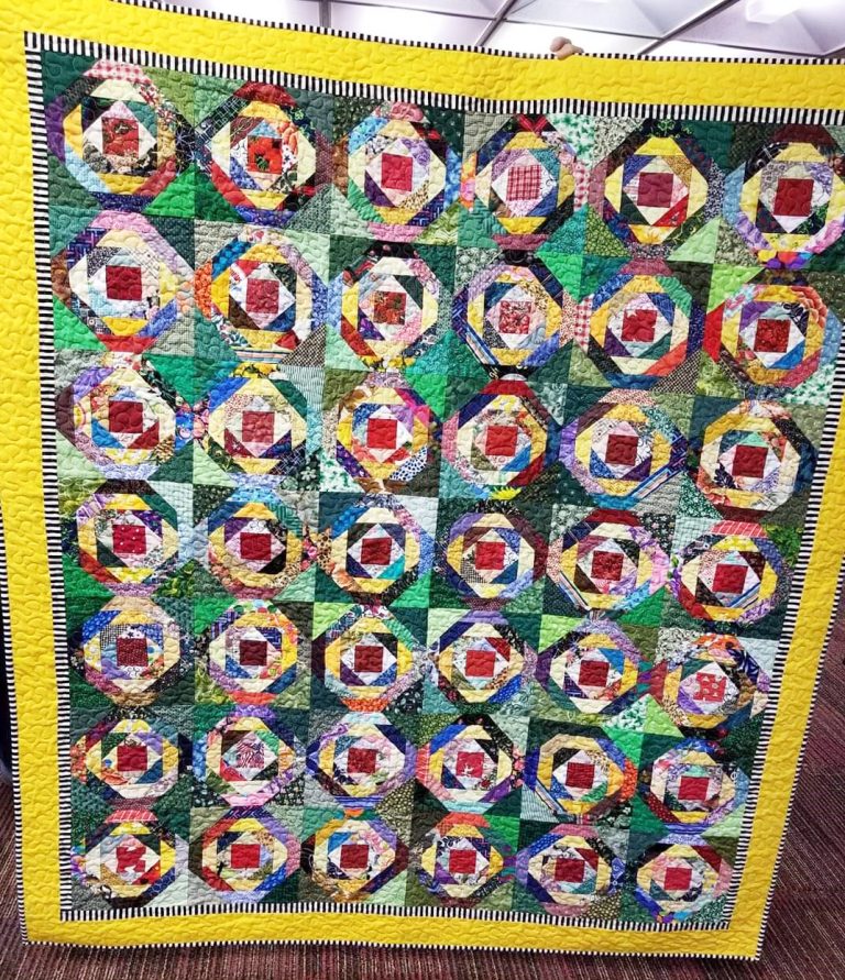 Brightly colored, hand sewn quilt