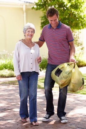 Man Helping Senior Woman With Shopping